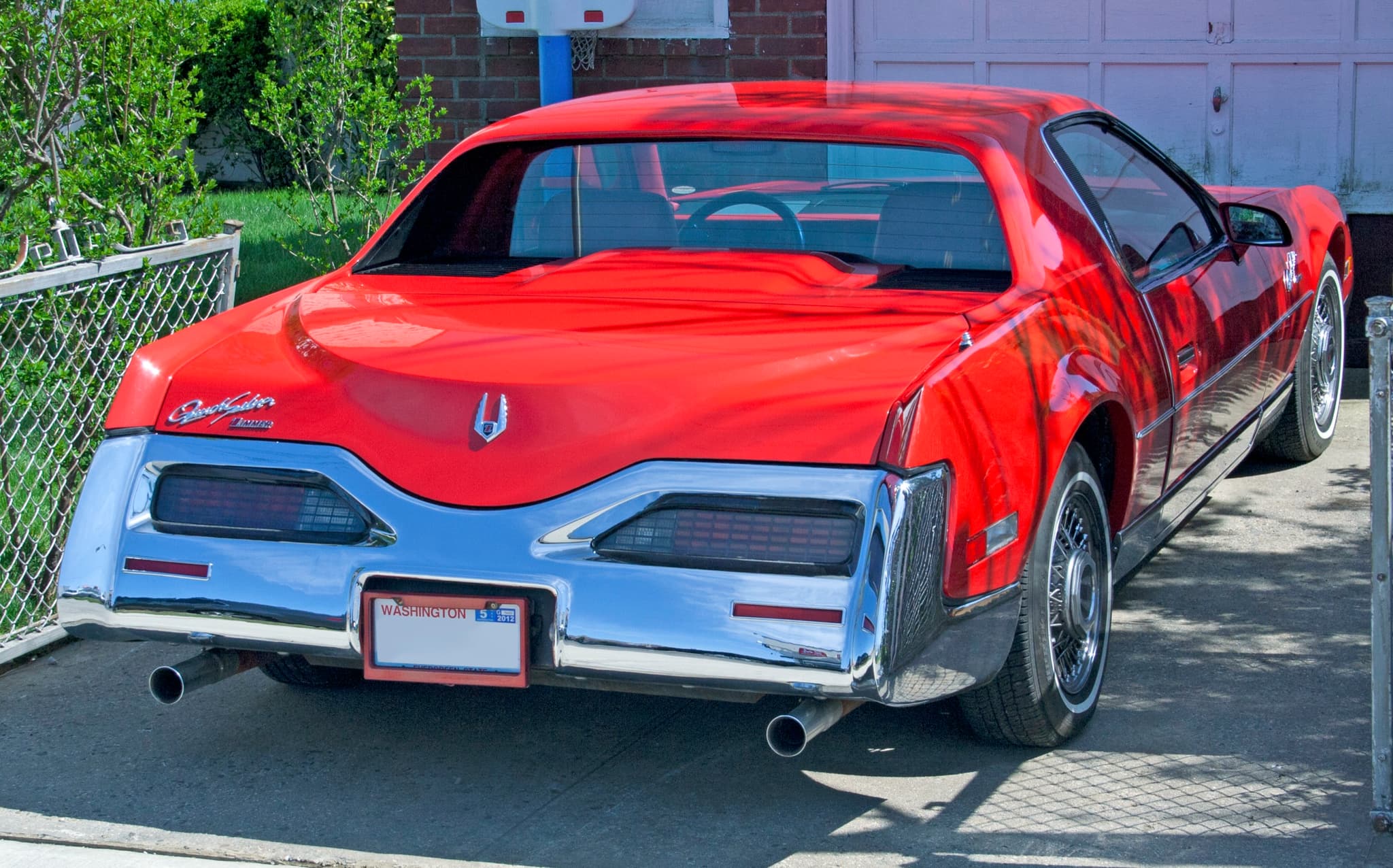 The rear of a red QuickSilver with a chrome bumper and twin tail-lamp clusters.